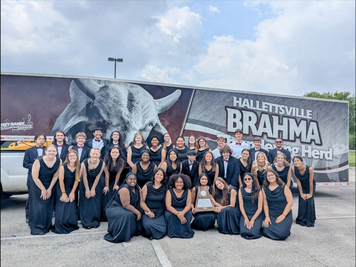 Picture of the band with their trophy.